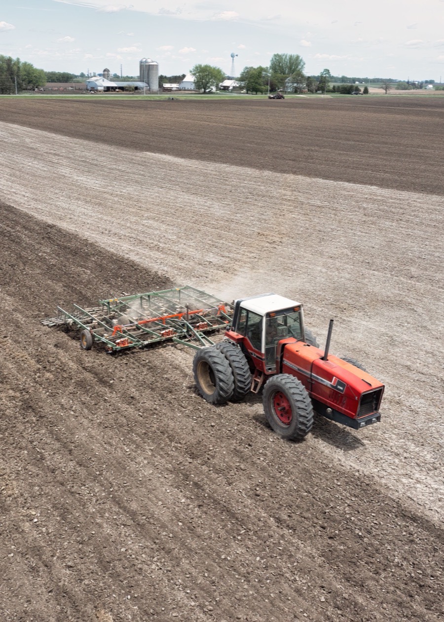 Tractor preparing a farm field for precision agriculture